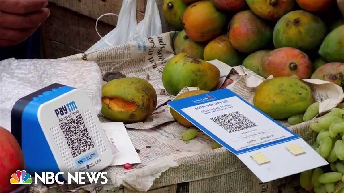 A fruit stall in India with a printed UPI QR code